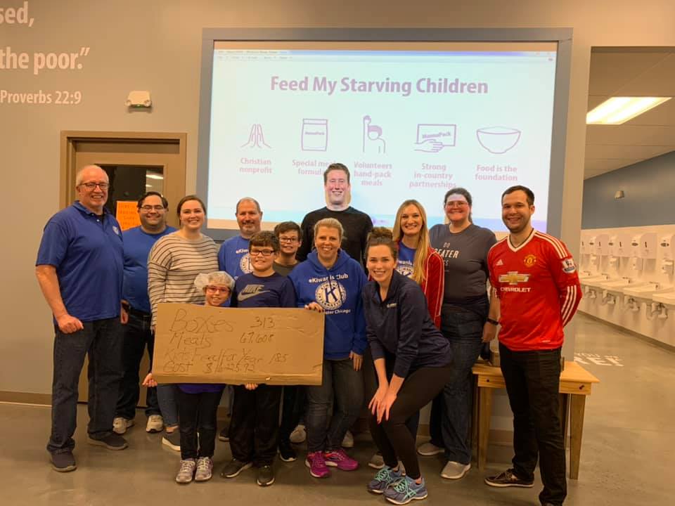 Group of approximately a dozen eKiwanis members gathered at Feed My Starving Children packing event